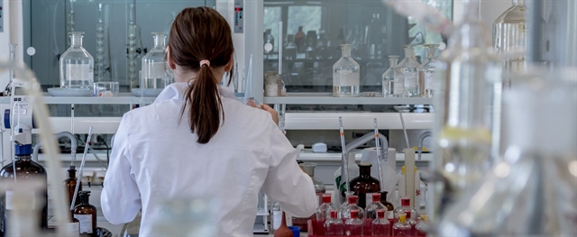 Back of woman working in a Chemical Lab