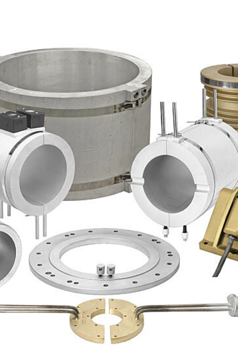 Assortment of Tempco cast-in heaters and thermal components in aluminum, brass and bronze, including band heaters, platens and ring castings